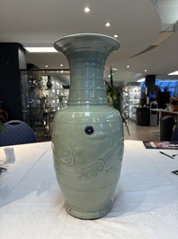 A Chinese celadon-glazed vase with relief lotus scroll design, 18th C.