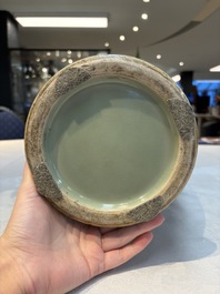 A Chinese celadon-glazed vase with relief lotus scroll design, 18th C.