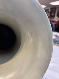 A Chinese celadon-glazed vase with relief lotus scroll design, 18th C.