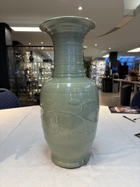 A Chinese celadon-glazed vase with relief lotus scroll design, 18th C.