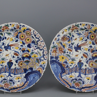 A pair of large polychrome Dutch Delft dishes with birds and flowers, 17th C.