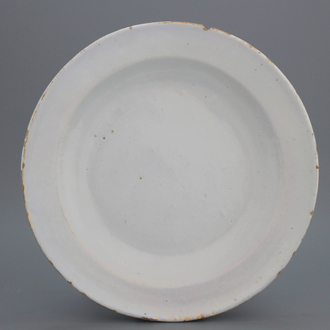 A monochrome white Dutch Delft dish of circular form, late 17th C.