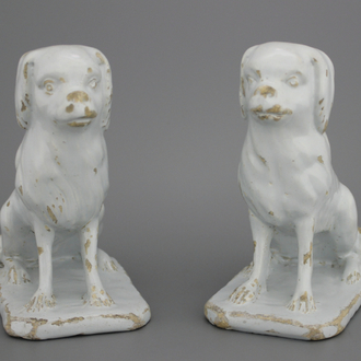 A pair of Dutch Delft monochrome white figures of dogs, 18th C.