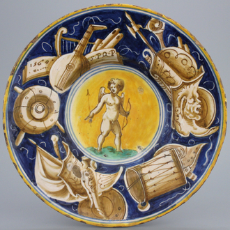 A Casteldurante maiolica plate with Cupid holding an arrow, dated 1560