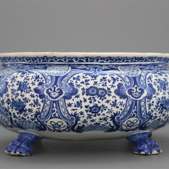 An oval shaped Dutch Delft blue and white wine cooler on 4 feet, Adrianus Kockx, late 17th C.