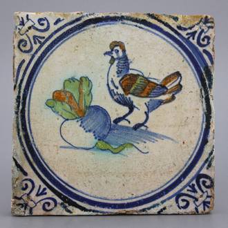 A very rare polychrome Dutch Delft tile with a rooster and a turnip, Haarlem ca. 1620