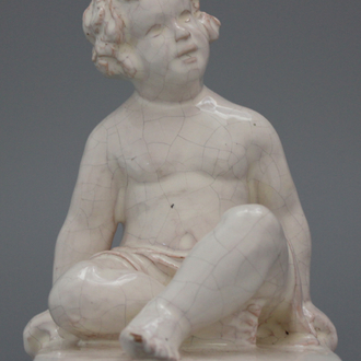 A pair of white faience book stands modelled as seated boys, Geo Martel, Dèsvres, early 20th C.