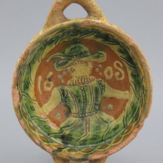 A Dutch slipware decorated porringer with a figure, dated 1608