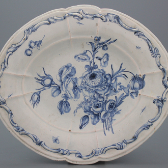 A large French faience relief molded oval blue and white dish with a very fine floral decoration, 18th C.