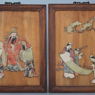 A pair of Chinese wooden panels with soap stone decoration, ca. 1900