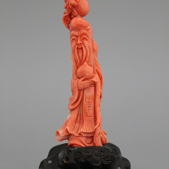 A carved Chinese red coral figure of Shou Lao, 19/20th C.