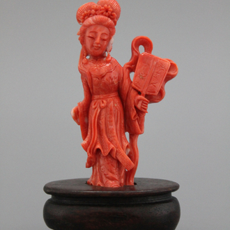 A carved Chinese red coral figure of a lady, 19/20th C.