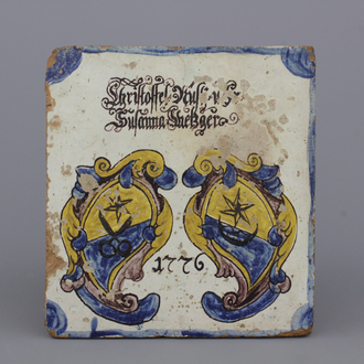 A German armorial stove tile, dated 1776 and inscribed