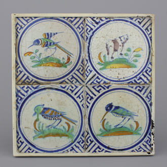 A framed set of 4 polychrome Dutch Delft tiles with a bear and birds, 17th C.
