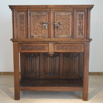 A Flemish oak credence with IHS panels, 16th C. with later adaptations