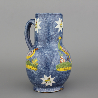 A rare Brussels faience blue ground jug with a peacock, 18th C.