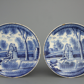 A pair of Dutch Delft blue and white romantic scene plates, 18th C.
