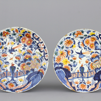 A pair of Dutch Delft polychrome chinoiserie plates with a bird on a fence, ca. 1700