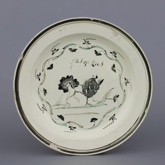 A Dutch-decorated English Leeds orangist creamware plate with a dog and inscription, 18th C.