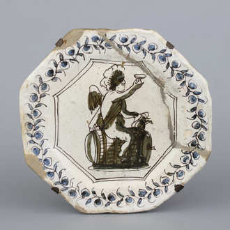 A rare Dutch Haarlem maiolica plate with Bacchus on a barrel, 17th C.