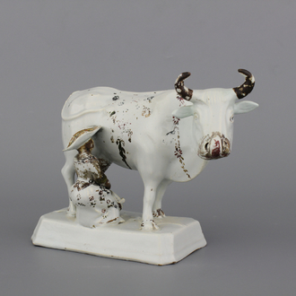 A white Delft cold-painted cow and milker group, 18th C.
