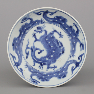 A Chinese porcelain blue and white dragon plate, 18th C.