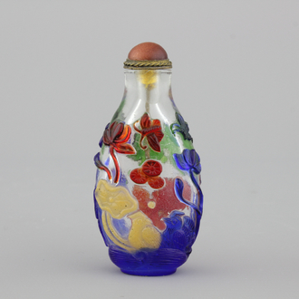 A Chinese overlay glass snuff bottle with ducks in a pond and flowering lillies