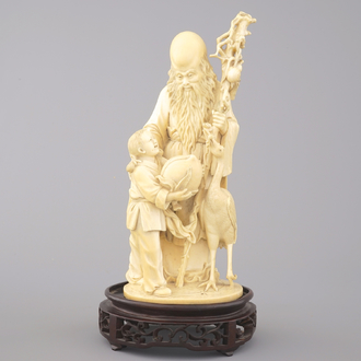 A Chinese carved ivory figure of an immortal, Shou, with a child, 19/20th C.