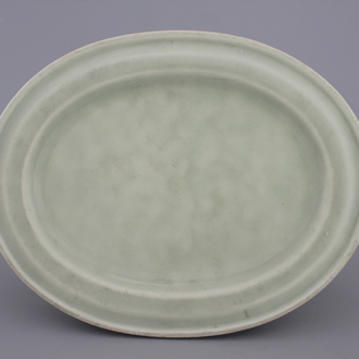 A Chinese porcelain celadon plate warmer, 18/19th C.