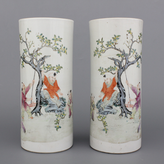 A pair of Chinese porcelain hat stands with playing boys, 19th C.