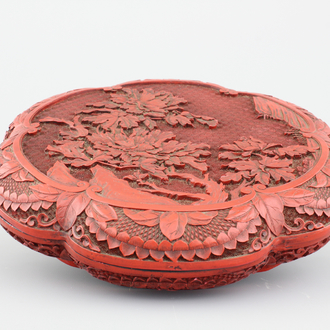 A Chinese carved cinnabar lacquer box and cover, 19th C.