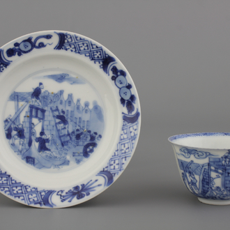 A Chinese porcelain blue and white cup and saucer with a "Rotterdam Riot" decor, Kangxi