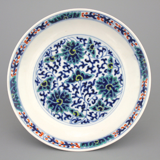 A Chinese porcelain doucai lotus scroll plate, 19th C.