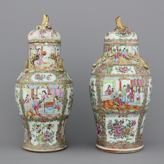 Two Chinese porcelain Canton vases and covers, 19th C.