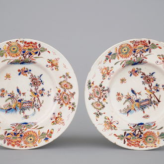 A fine pair of polychrome Dutch Delft plates with birds among flowers, early 18th C.