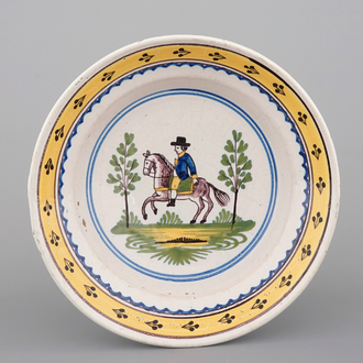 A Brussels faience plate with a knight on horseback, 18th C.