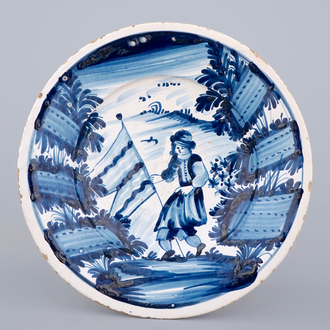 A Spanish Catalan blue and white dish with a flag-bearer, late 17th C.
