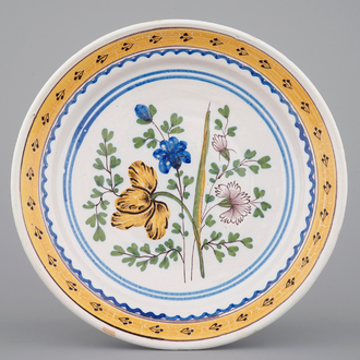 A Brussels faience plate with a bouquet of flowers, 18th C.