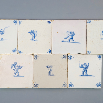 A set of 7 Dutch Delft blue and white tiles with putti or amors, 17/18th C.