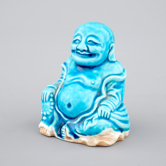 A Chinese porcelain turquoise figure of a seated Buddha, Kangxi