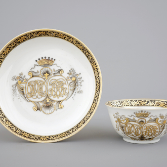 A Chinese grisaille and gilt export porcelain armorial cup and saucer, 18th C