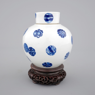 A Chinese blue and white globular jar with cover on a wooden stand, early 19th C.