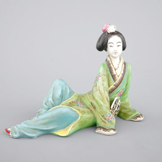 A Chinese famille rose porcelain figure of a reclining lady, 20th C