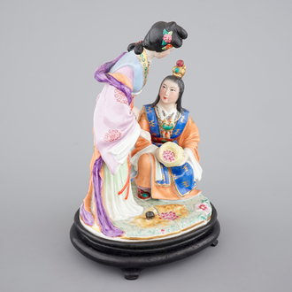 A fine Chinese porcelain figural group on a wooden stand, 20th C