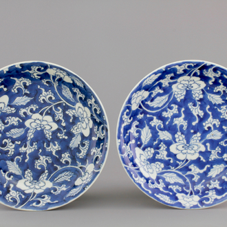 A nice pair of Chinese blue gound plates with peony scrolls, Kangxi, ca. 1700