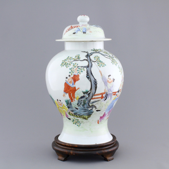 A Chinese famille rose porcelain vase with playing boys on a wooden stand, 19th C.