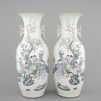A tall pair of Chinese famille rose vases with beauties in a garden, 19th C.
