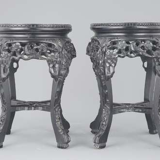 A pair of Chinese carved darkened wood vase stands with marble top, 20th C.