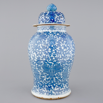 A tall blue and white Chinese porcelain vase and cover with lotus scrolls, 19th C.