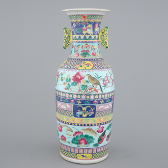 A tall Chinese famille rose vase with birds among flowers between colored bands of symbolim, 19th C.